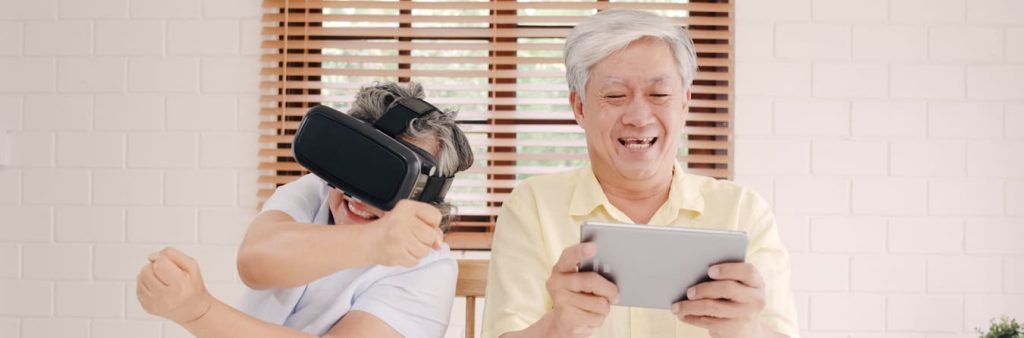 Clermont Park Senior Living Community in Denver, CO - asian elderly couple using tablet vr