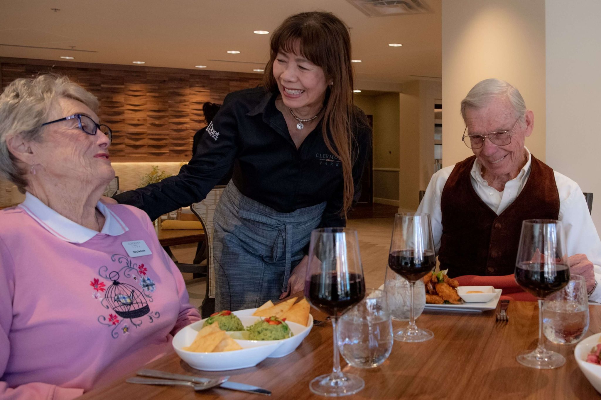 Clermont Park Senior Living Community in Denver, CO - dining team member and residents talking