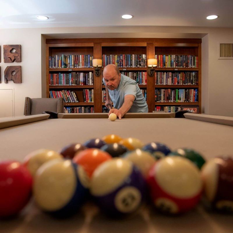 Clermont Park Senior Living Community in Denver, CO - older man playing pool square