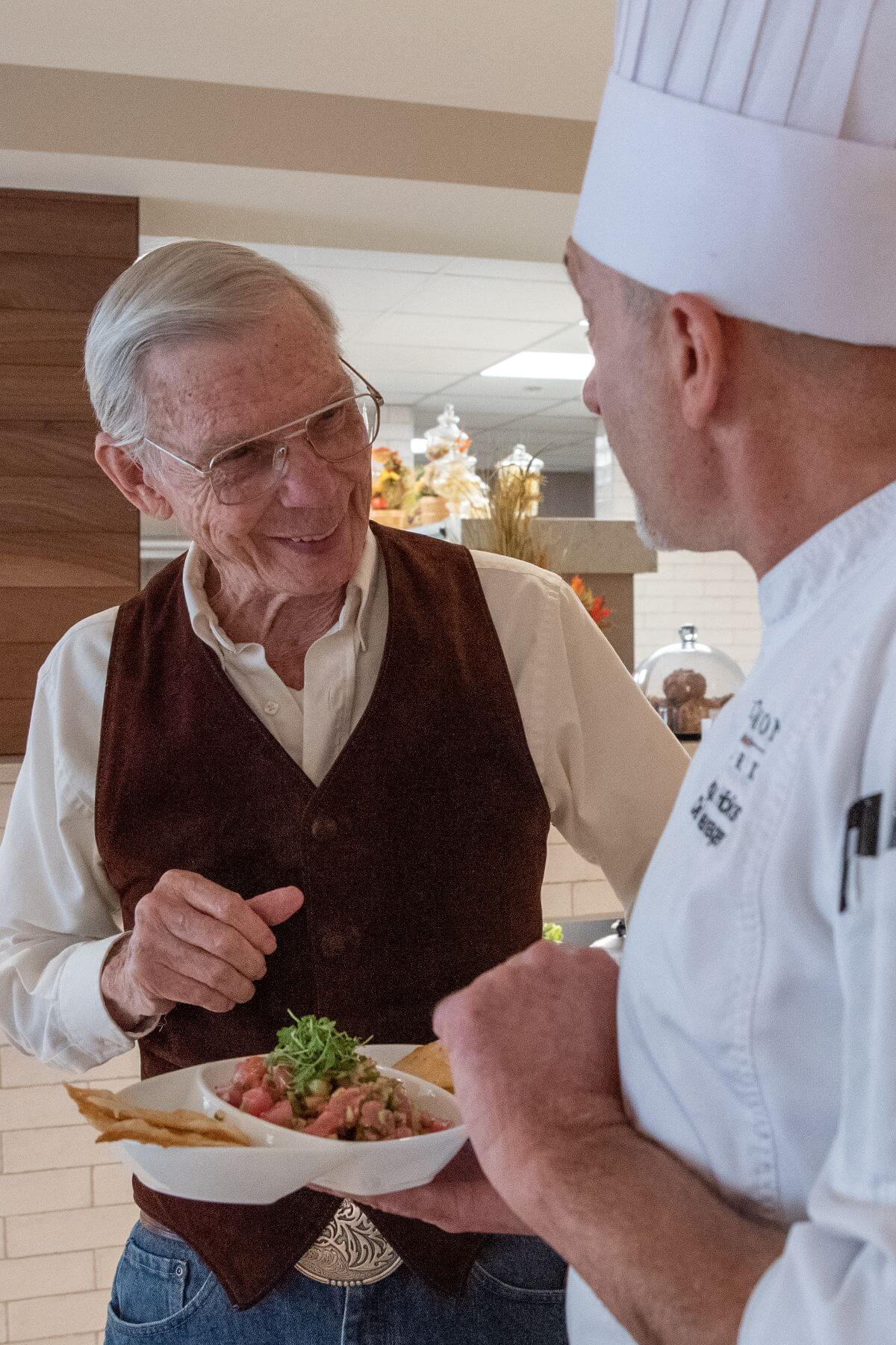 Clermont Park Senior Living Community in Denver, CO - older man and chef talking