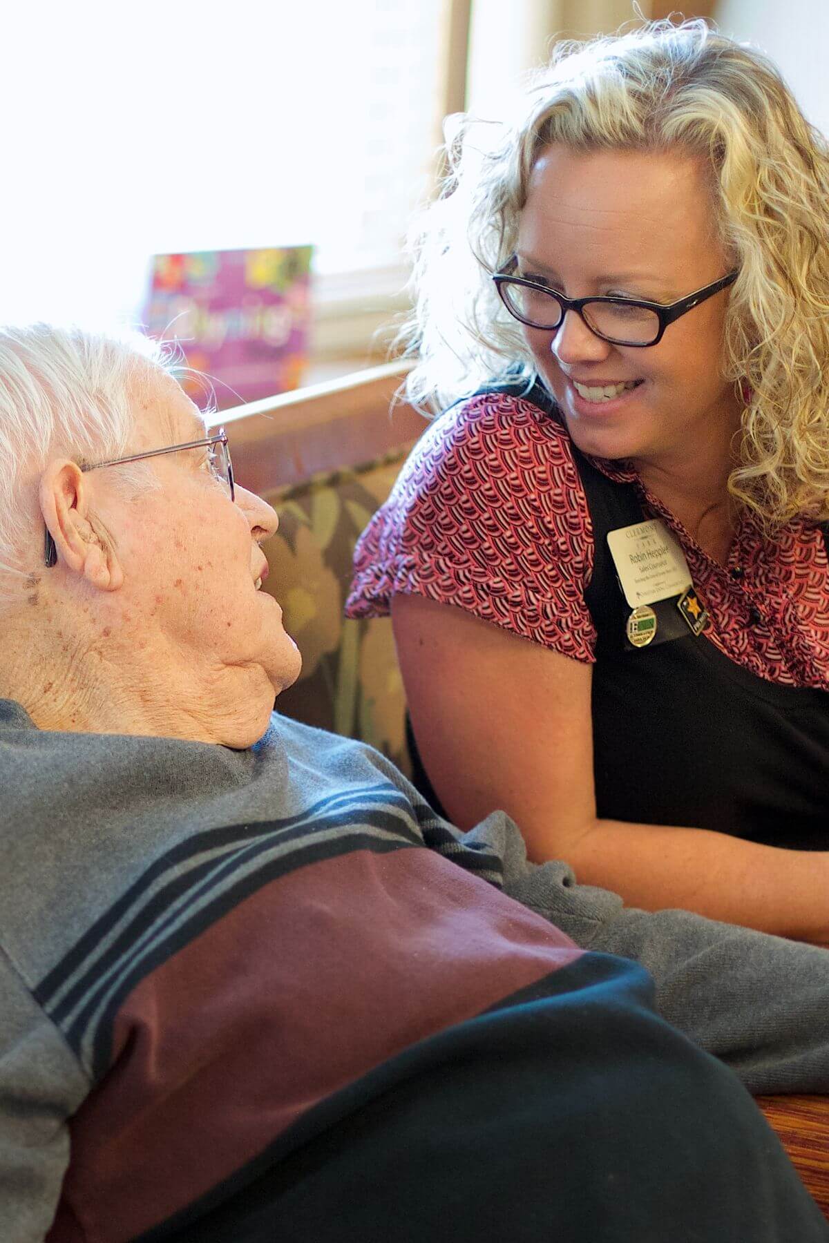 Clermont Park Senior Living Community in Denver, CO - older man and team member talking portrait