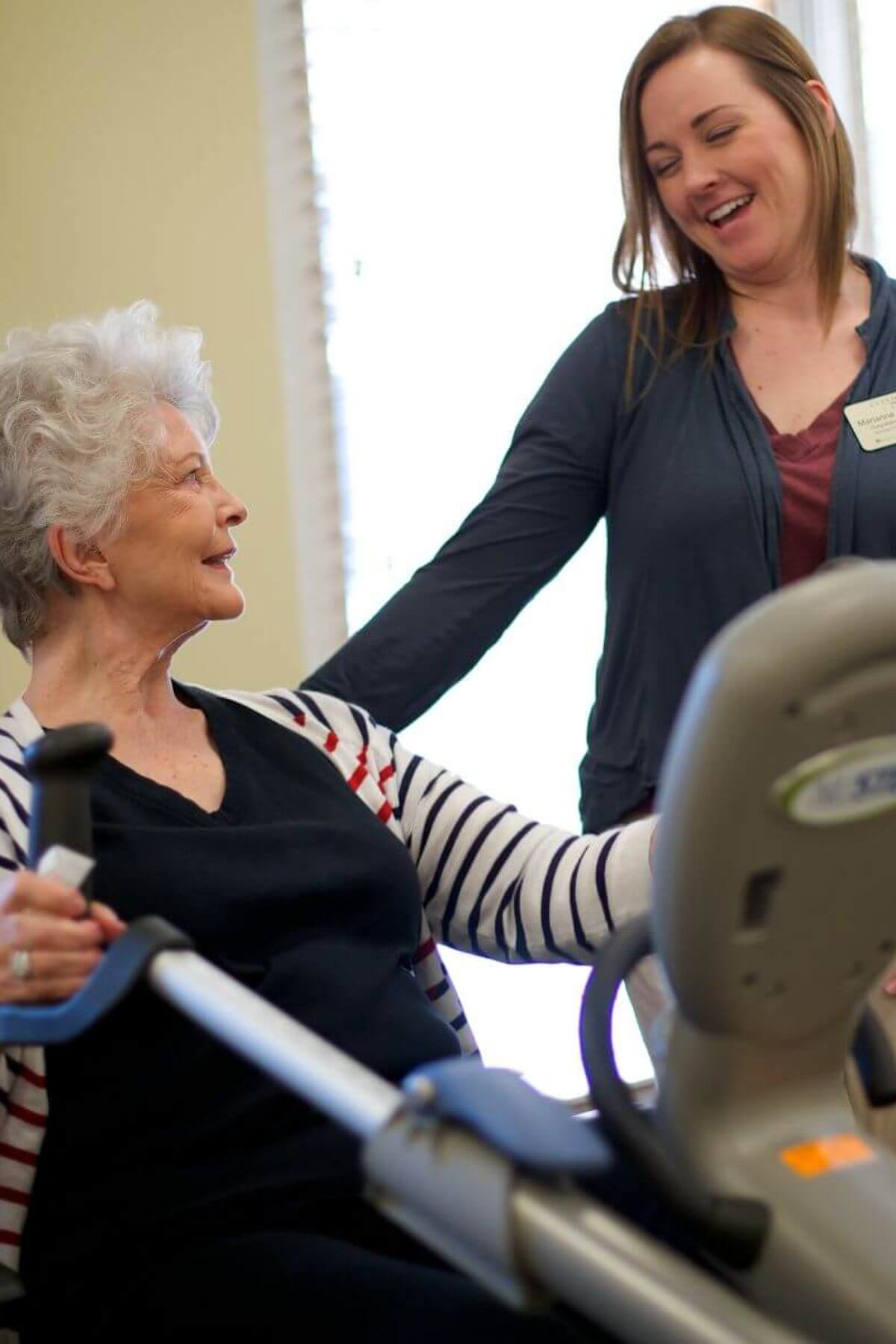 Clermont Park Senior Living Community in Denver, CO - physical therapist and older woman talking