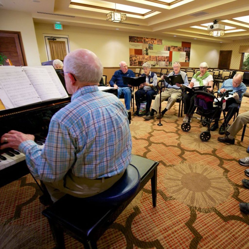 Clermont Park Senior Living Community in Denver, CO - older adults sing during choir rehearsal