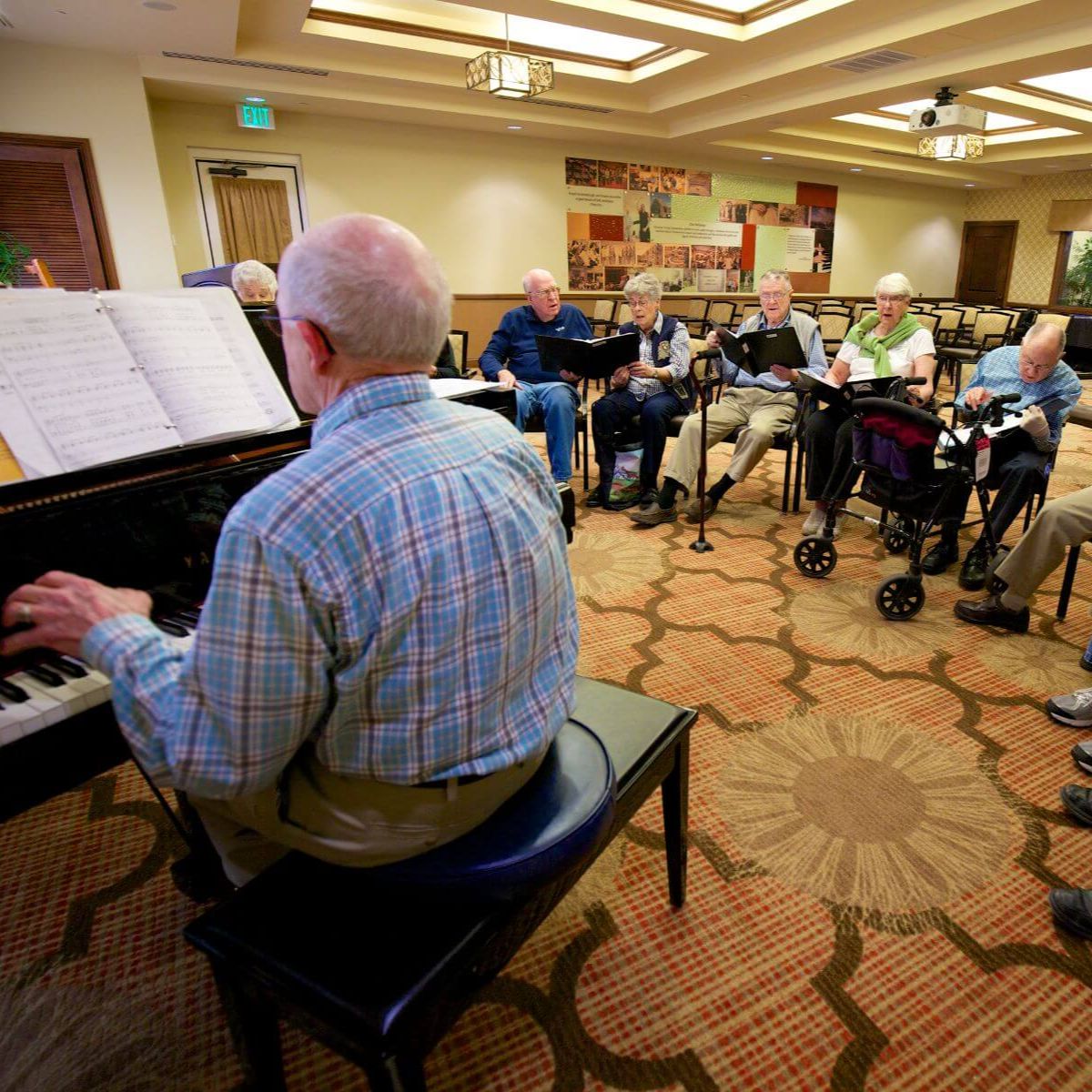 Clermont Park Senior Living Community in Denver, CO - older adults sing during choir rehearsal