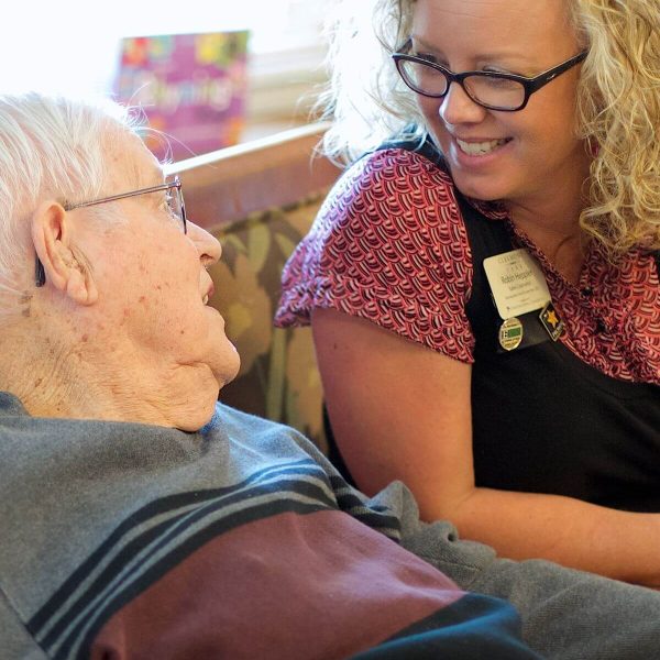 Clermont Park Senior Living Community in Denver, CO - older man and team member talking portrait